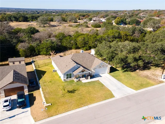 an aerial view of residential houses with outdoor space