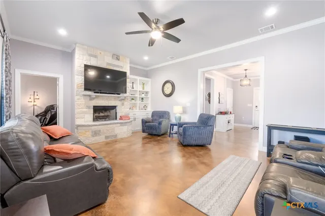 a living room with furniture flat screen tv and a fireplace