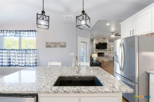 a kitchen with a refrigerator a sink and a stove