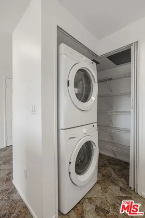 a view of a building with many windows and trees