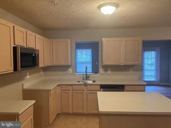 wooden floor in an empty room with a fireplace