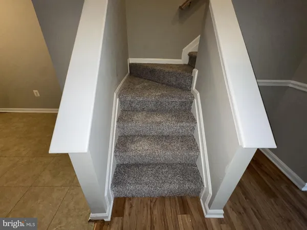 a view of a room with wooden floor and brick walls