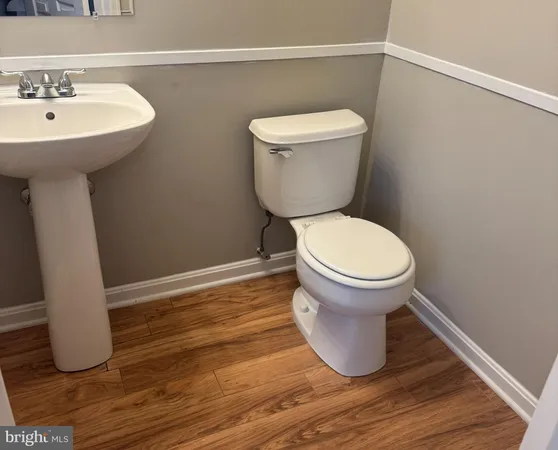 a bathroom with a sink toilet and a mirror