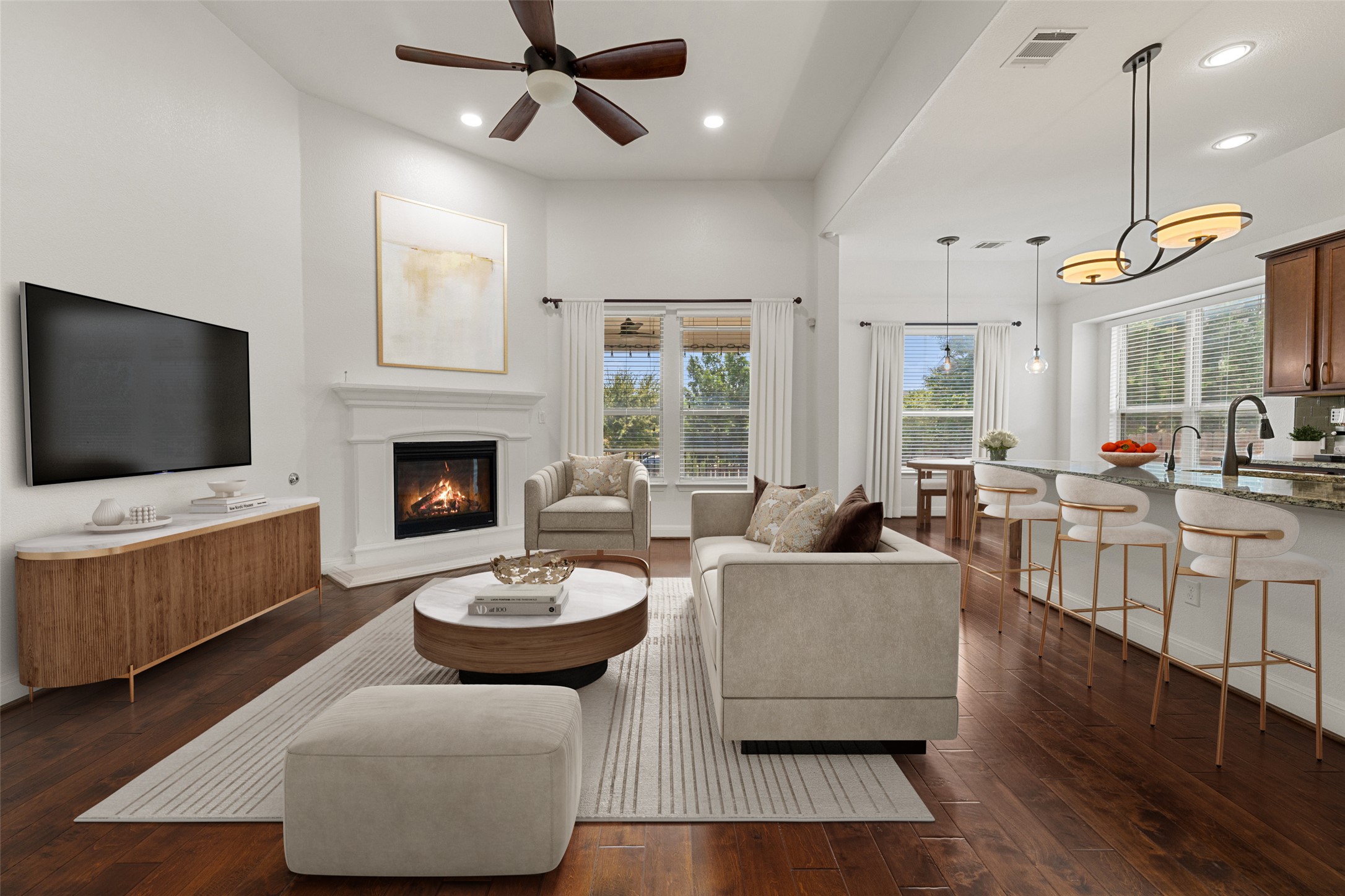 Living room featuring dark wood-type flooring, a glass covered fireplace, recessed lighting, and a ceiling fan