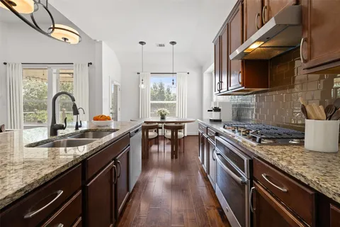 a view of a balcony with a floor to ceiling window and wooden fence