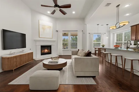 a kitchen with stainless steel appliances granite countertop a stove and a wooden floors