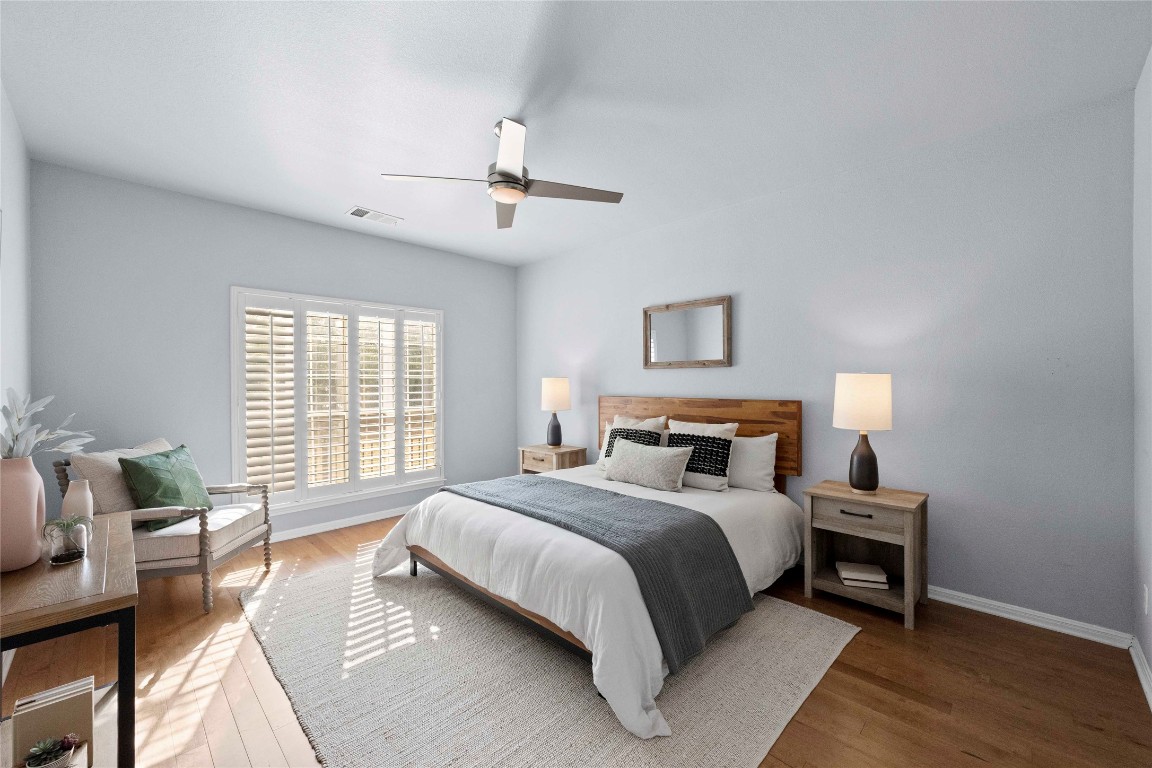 6704 Menchaca Road, Unit 29 Austin, TX 78745 - Photo 14 of 34 a bedroom with a bed a chandelier and a window