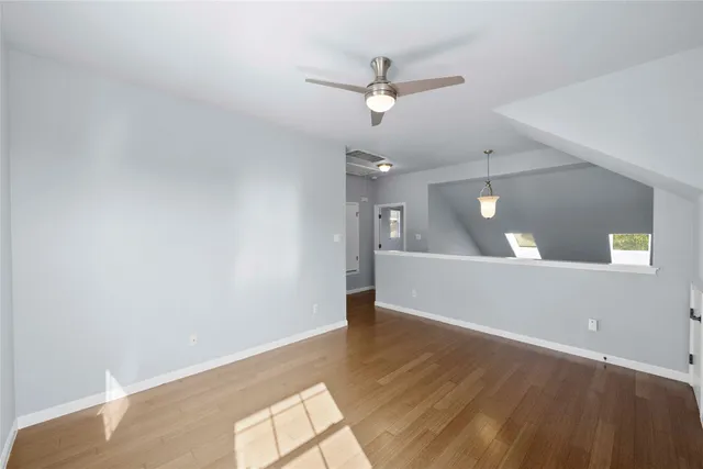 a view of empty room with wooden floor