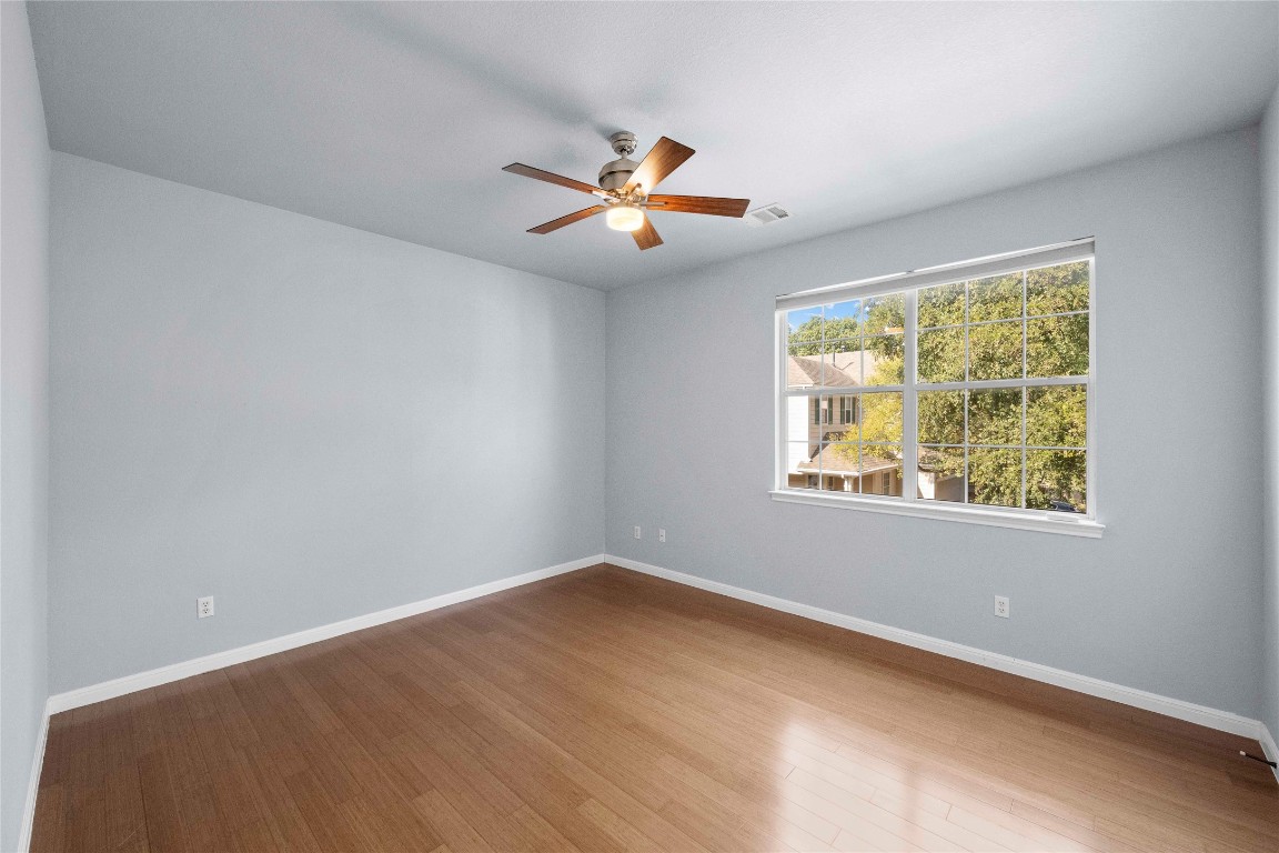 6704 Menchaca Road, Unit 29 Austin, TX 78745 - Photo 25 of 34 an empty room with windows and fan