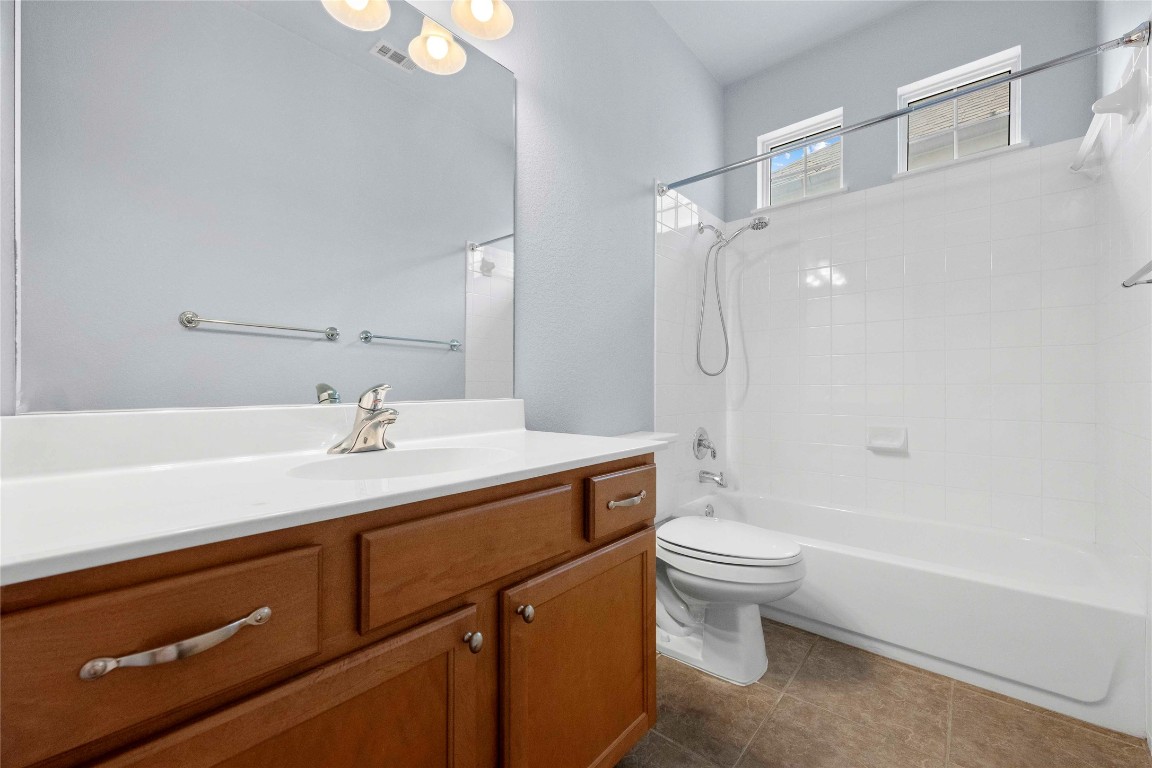6704 Menchaca Road, Unit 29 Austin, TX 78745 - Photo 26 of 34 a bathroom with a sink a toilet and shower