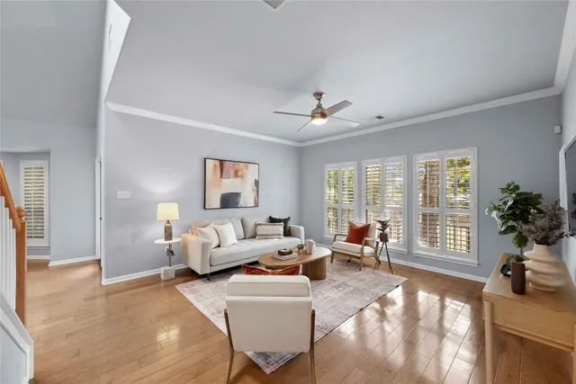 a living room with furniture and large windows