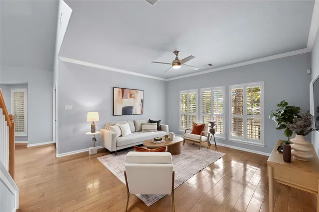 a living room with furniture and large windows