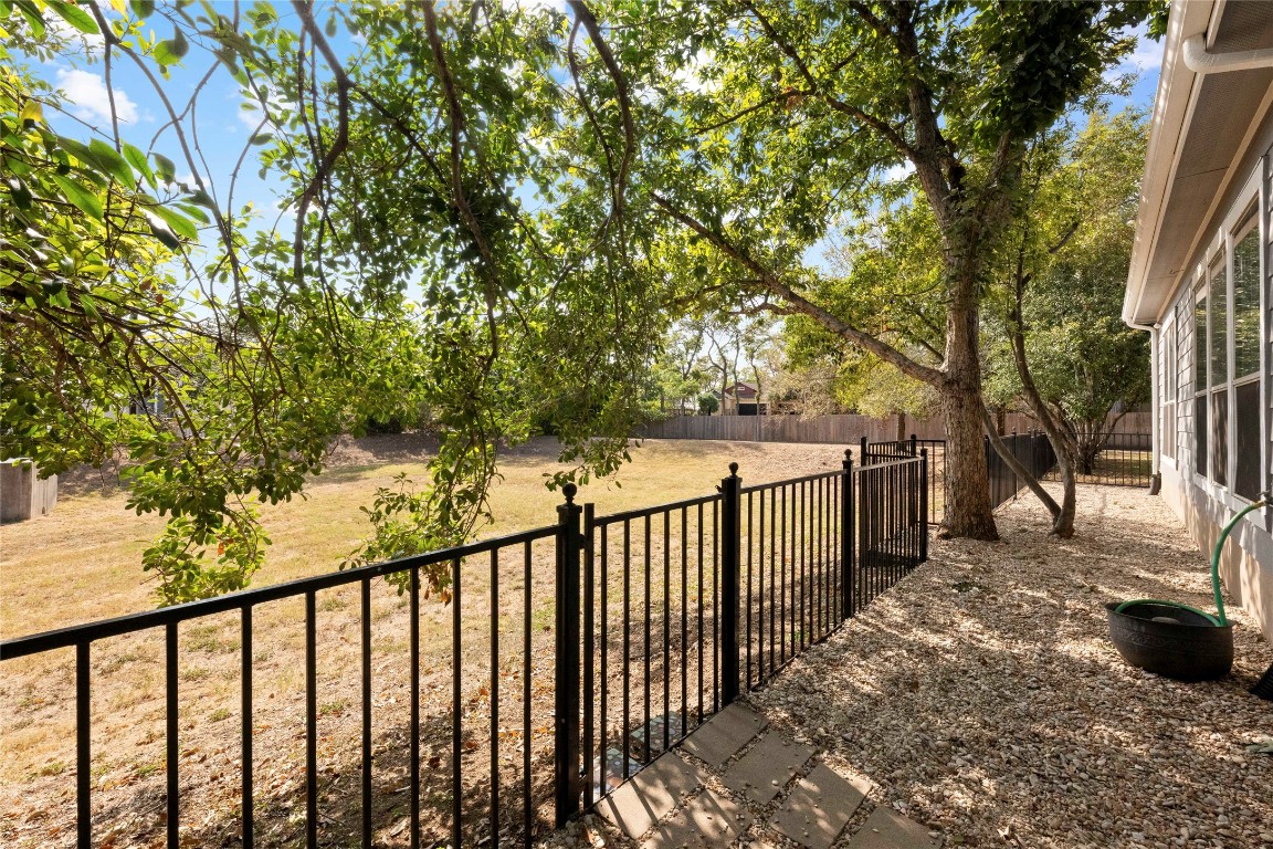 6704 Menchaca Road, Unit 29 Austin, TX 78745 - Photo 31 of 34 a view of a pathway with a wrought fence