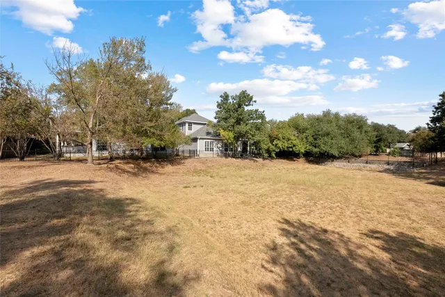 a view of large tree with snow on the road