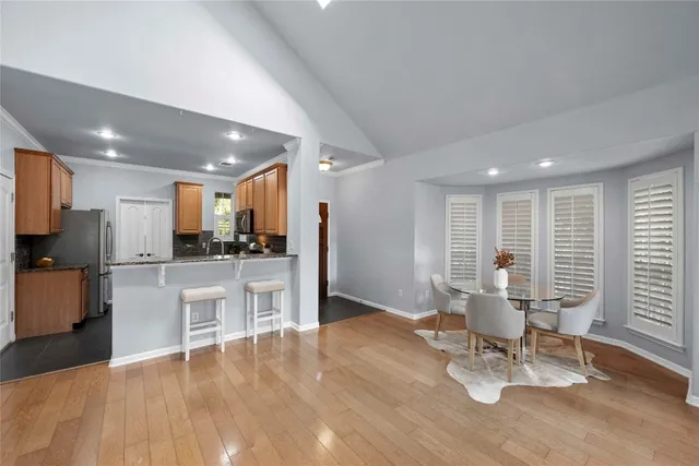a view of a kitchen with dining room and windows