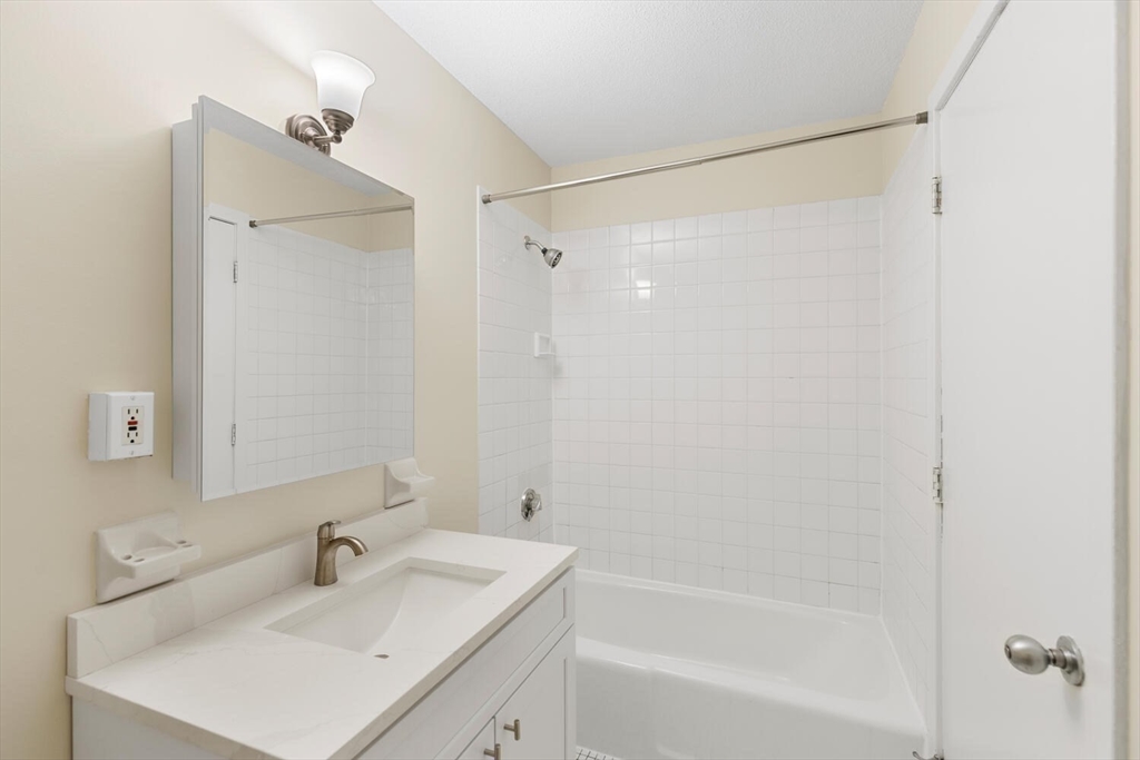 676 Huron Avenue, Unit 43 Cambridge, MA 02138 - Photo 11 of 20 a bathroom with a sink and a mirror