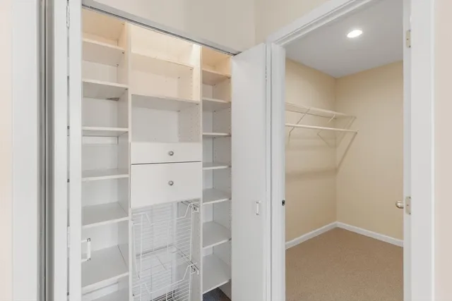 a view of walk in closet with empty racks