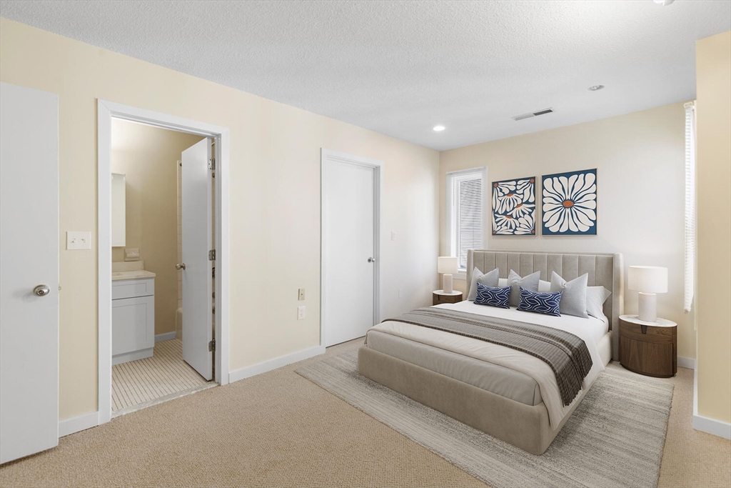 676 Huron Avenue, Unit 43 Cambridge, MA 02138 - Photo 10 of 20 a bedroom with a large bed and a painting