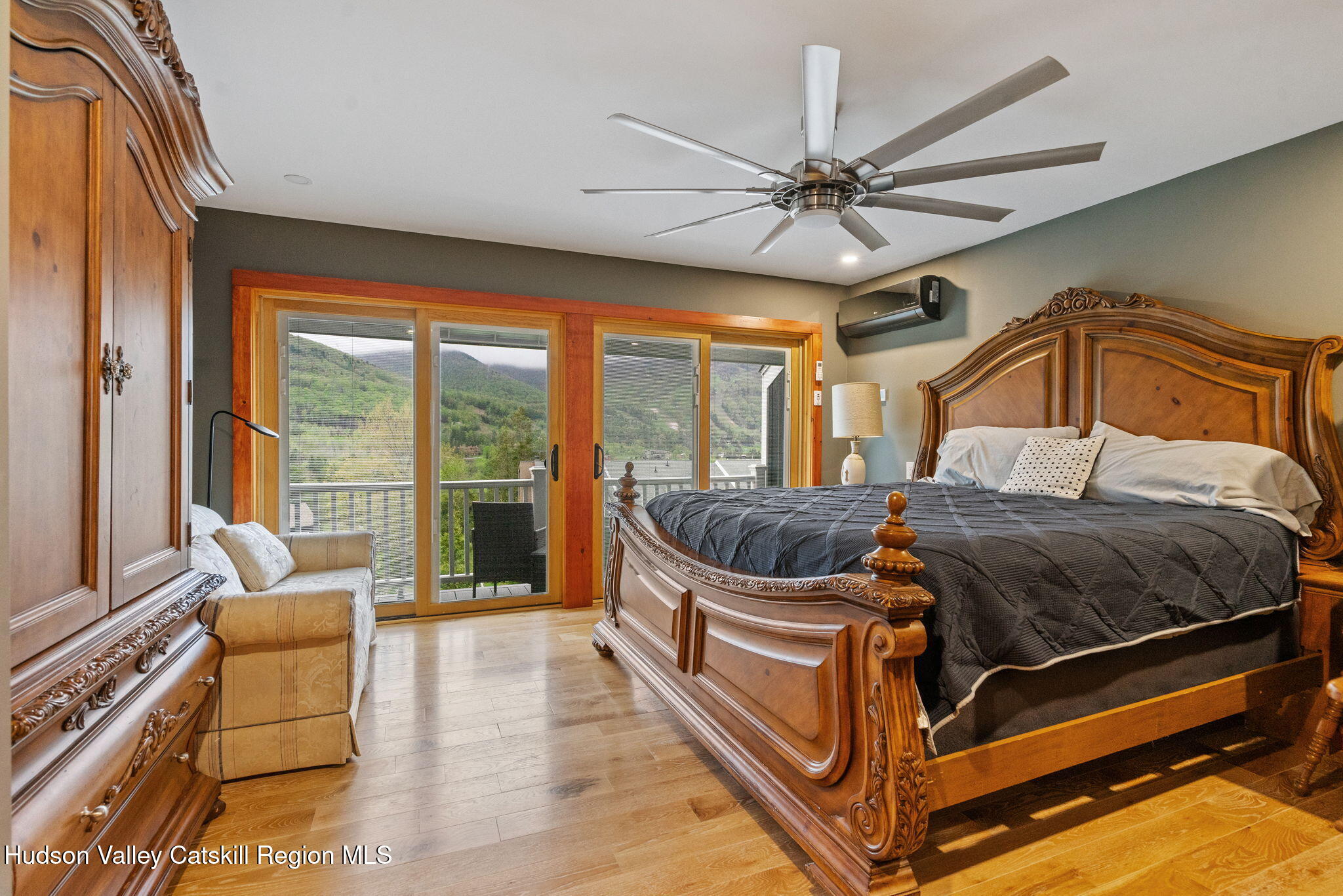 35 Scribner Hollow Road, Unit E3 Hunter, NY 12442 - Photo 24 of 59 a bedroom with a bed and a chandelier