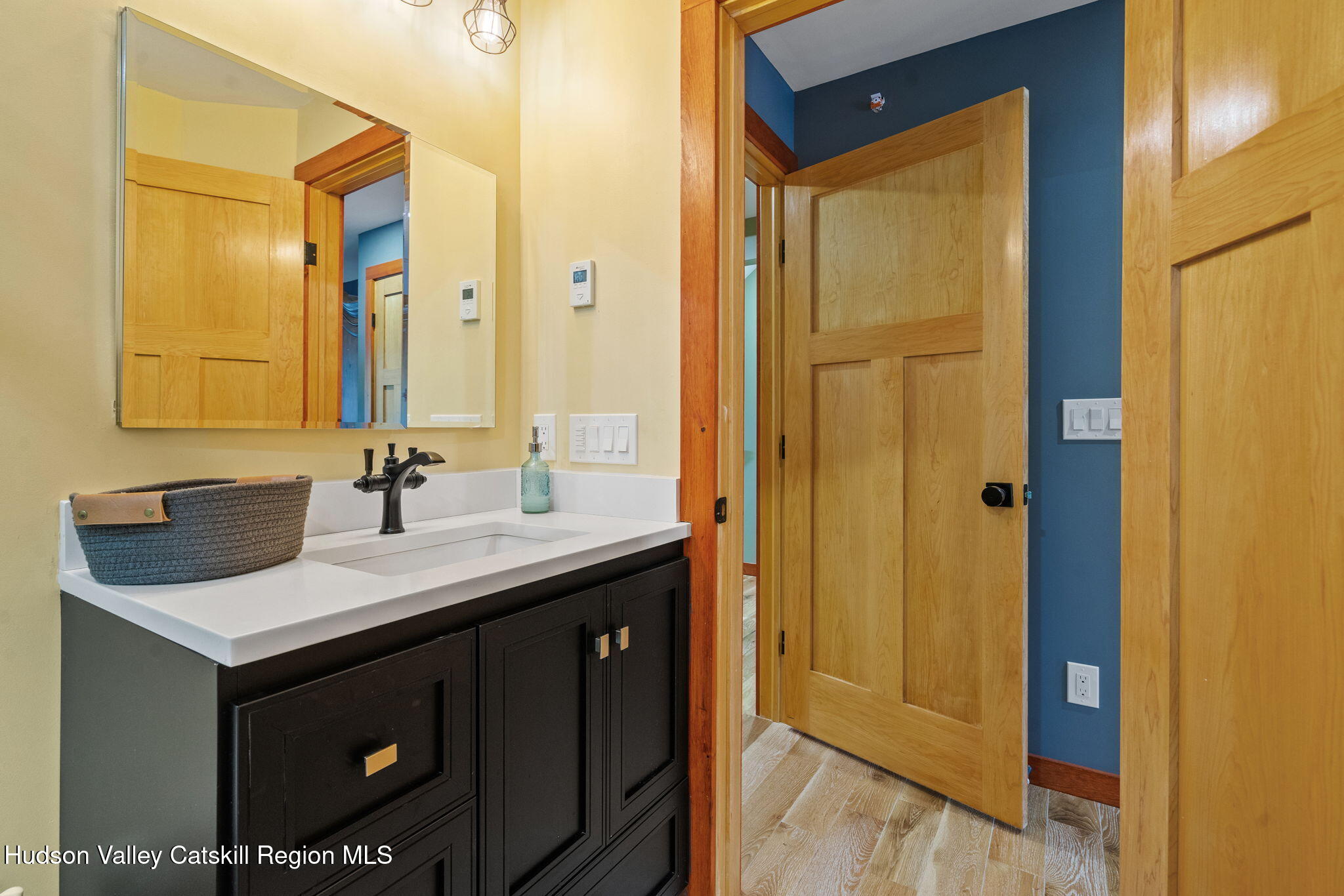 35 Scribner Hollow Road, Unit E3 Hunter, NY 12442 - Photo 30 of 59 a bathroom with a sink a mirror and a shower