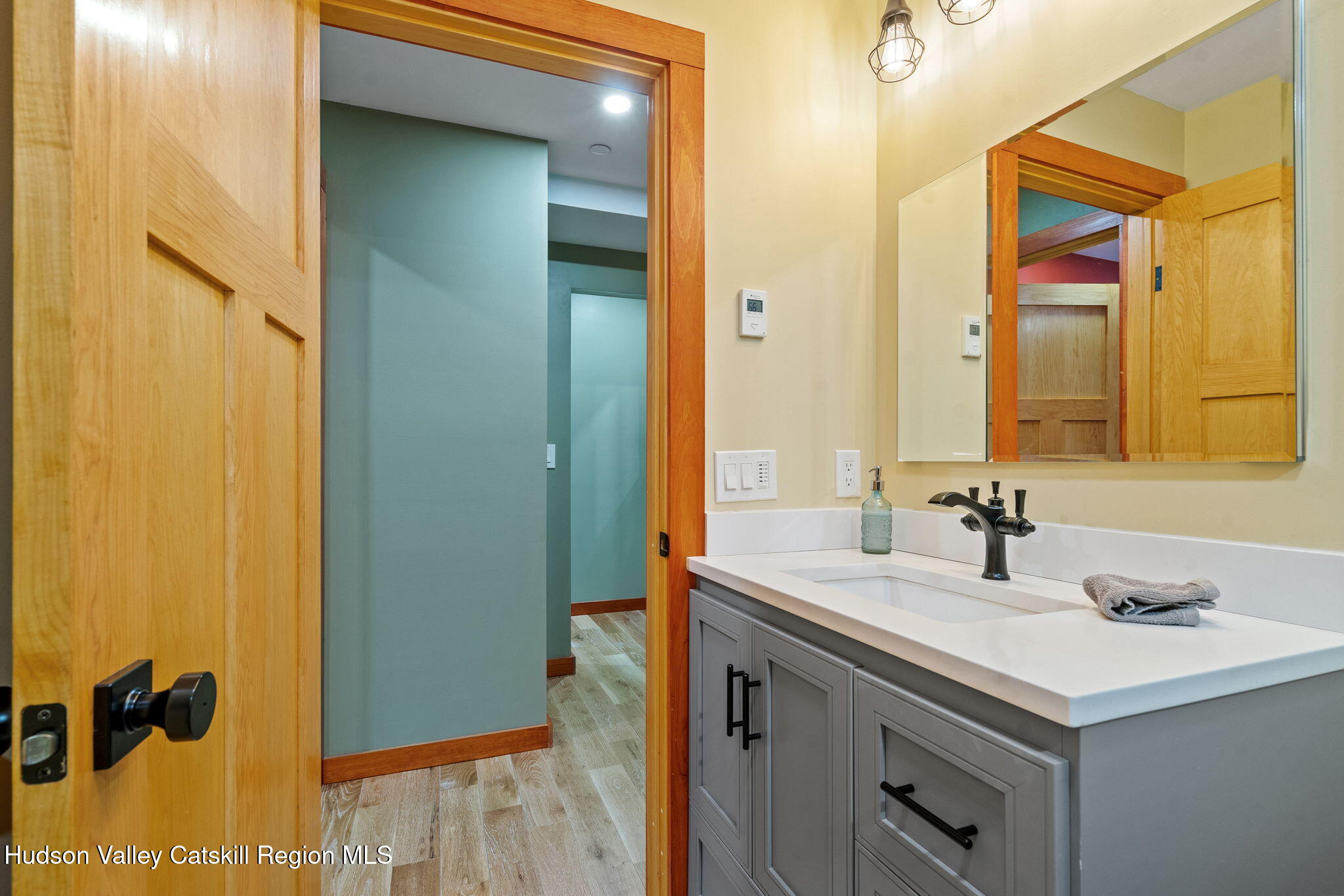 35 Scribner Hollow Road, Unit E3 Hunter, NY 12442 - Photo 32 of 59 a bathroom with a sink and a mirror