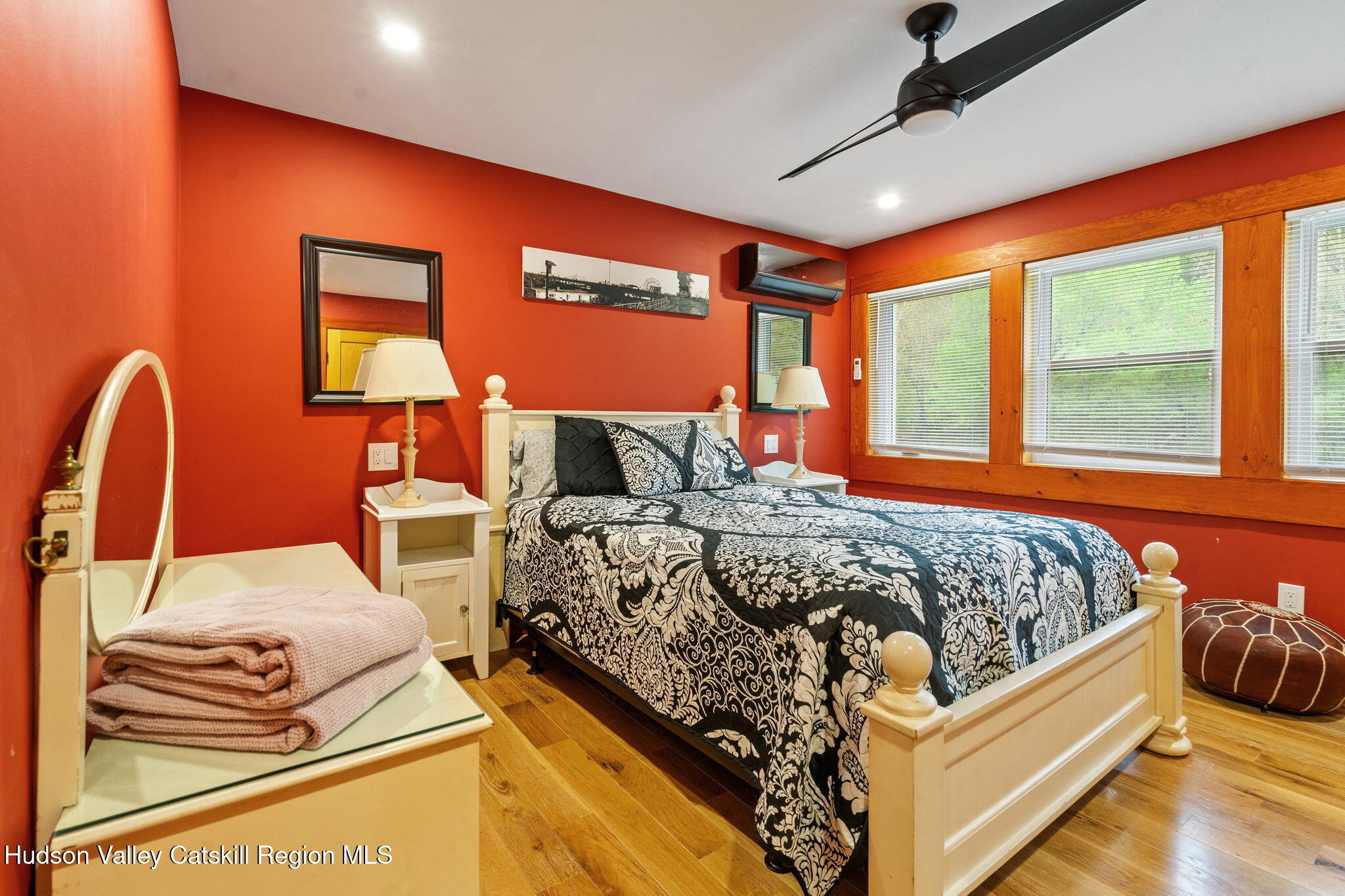 35 Scribner Hollow Road, Unit E3 Hunter, NY 12442 - Photo 33 of 59 a bedroom with a bed and dresser with wooden floor
