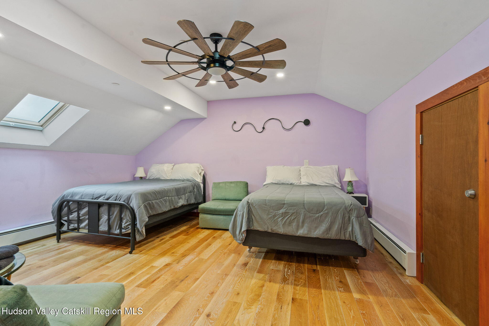 35 Scribner Hollow Road, Unit E3 Hunter, NY 12442 - Photo 37 of 59 a bedroom with a bed and a chandelier