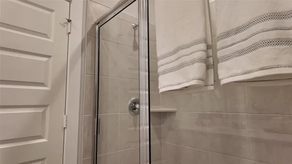 a bathroom with a glass door shower