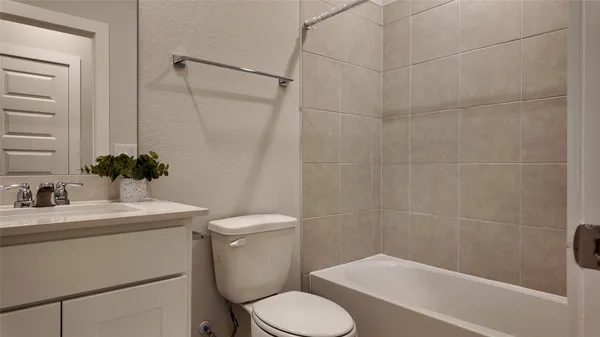 a white toilet sitting next to a bathroom sink