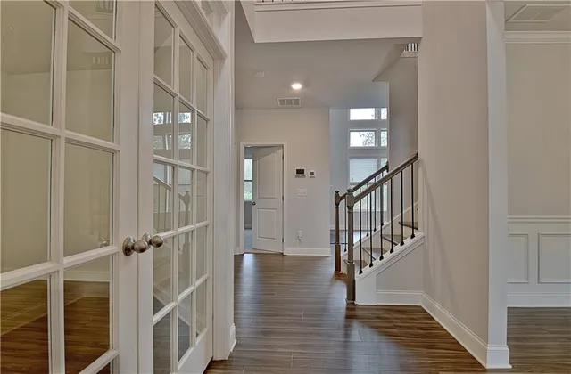 a view of kitchen with kitchen island wooden floors and stainless steel appliances