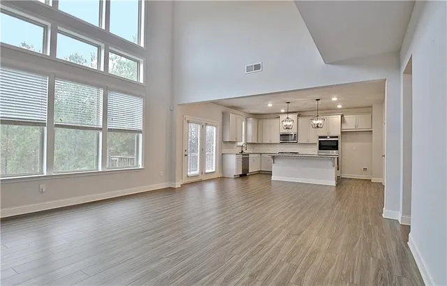 a view of a kitchen with wooden floor and a window