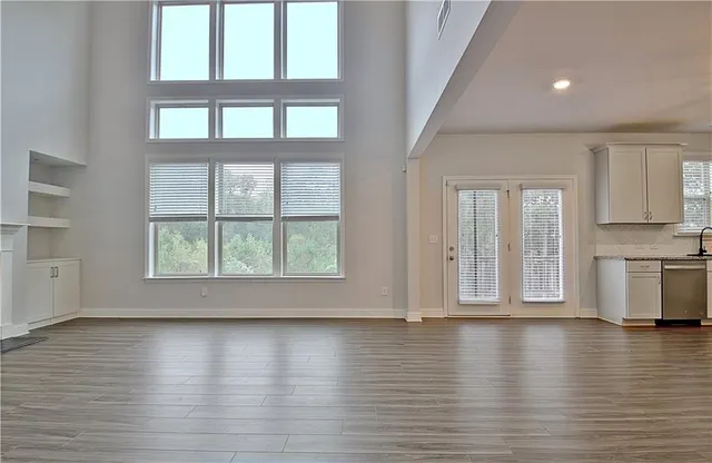a balcony with wooden floor and fence