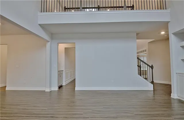 a large kitchen with cabinets wooden floor and stainless steel appliances