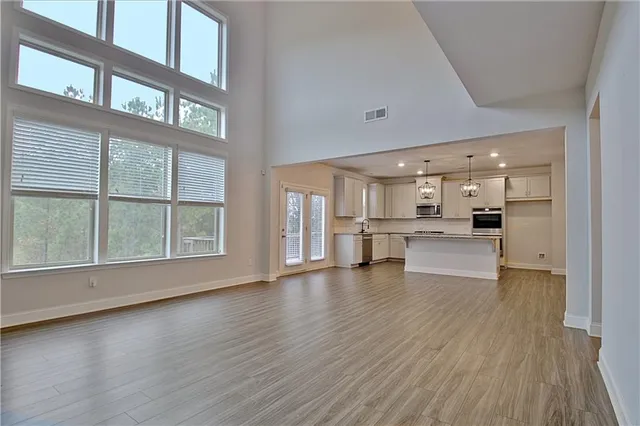 a kitchen with stainless steel appliances granite countertop a sink stove and cabinets
