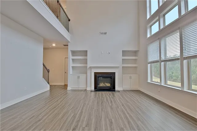 a kitchen with granite countertop white cabinets and stainless steel appliances