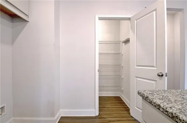 a view of entryway and hall with wooden floor