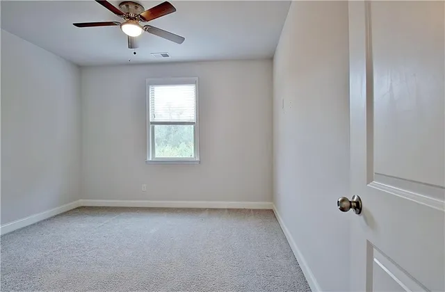 a view of a hallway with the wooden floor and staircase