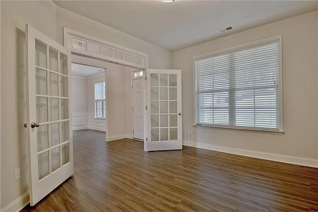 a view of an empty room with a fireplace and a window
