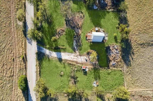 an aerial view of a house with a yard