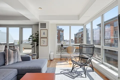 a living room with furniture and a floor to ceiling window