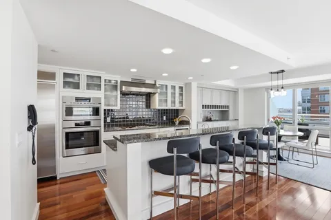 a kitchen with stainless steel appliances granite countertop a stove and a sink