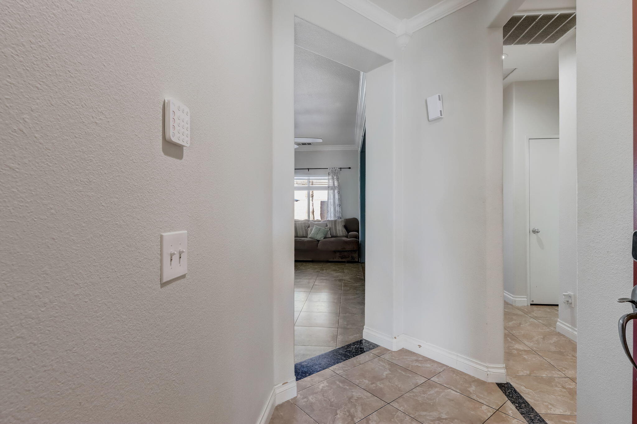 41163 Morris Street Indio, CA 92203 - Photo 11 of 83 a view of a hallway to an empty room with wooden floor and a bedroom