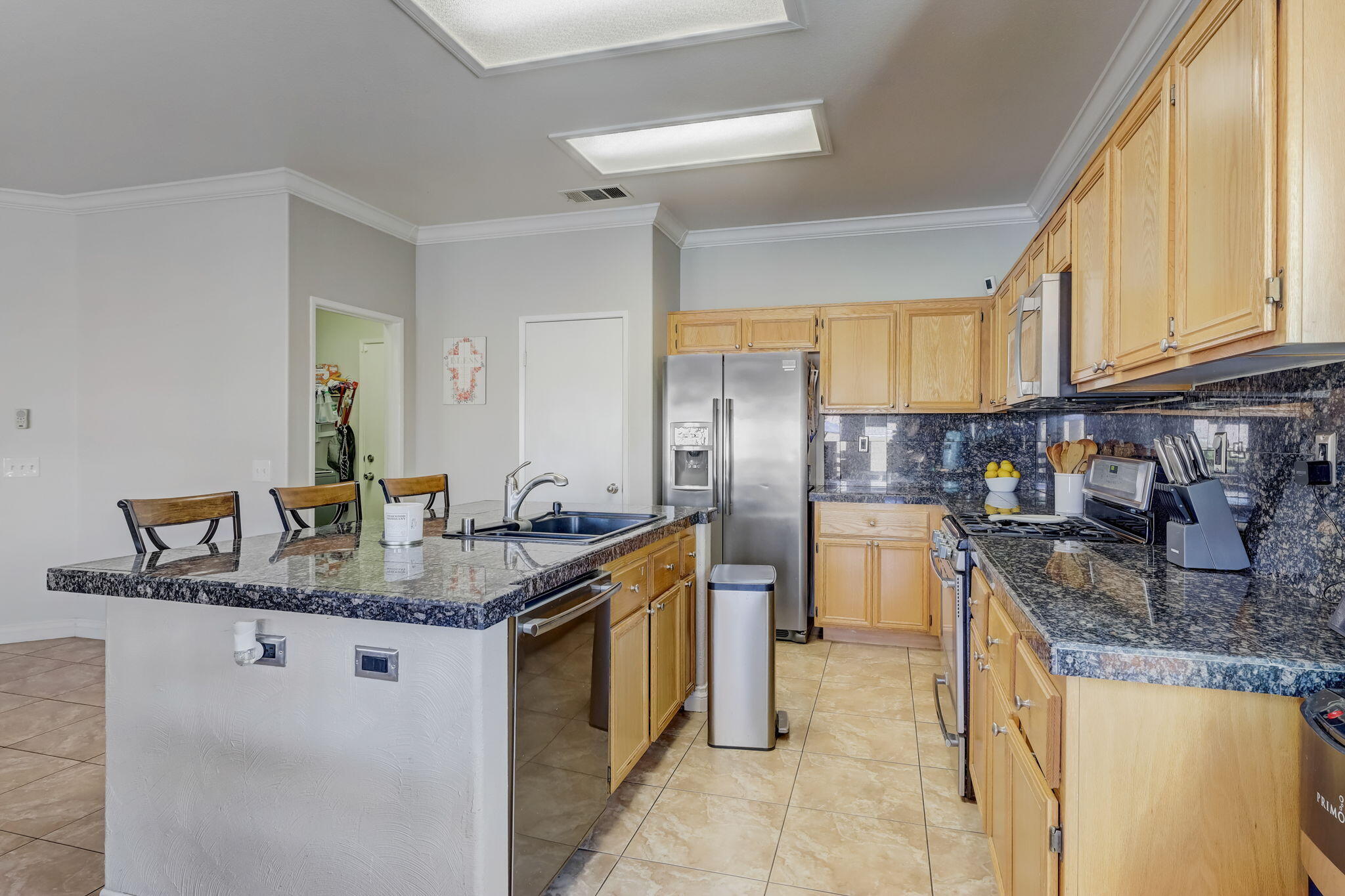 41163 Morris Street Indio, CA 92203 - Photo 25 of 83 a kitchen with stainless steel appliances granite countertop a sink stove and refrigerator