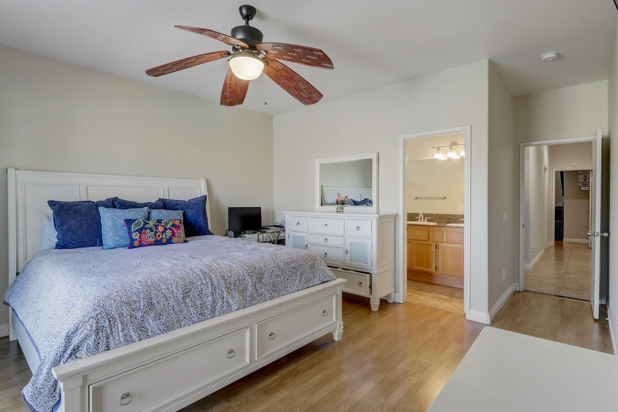 41163 Morris Street Indio, CA 92203 - Photo 37 of 83 a spacious bedroom with a bed and a chandelier