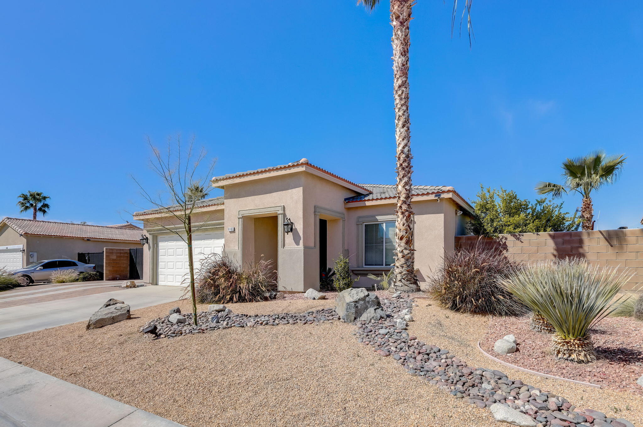 41163 Morris Street Indio, CA 92203 - Photo 4 of 83 a front view of a house with a yard