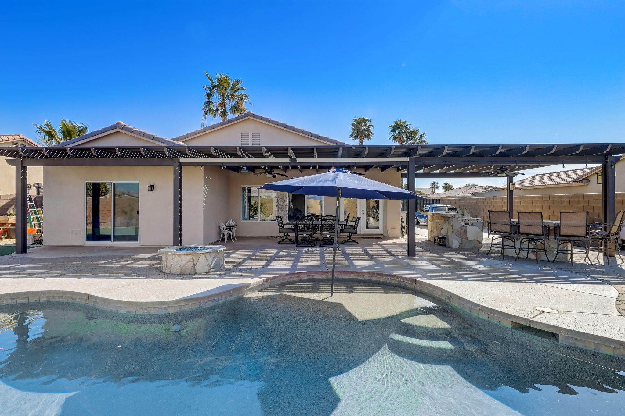 41163 Morris Street Indio, CA 92203 - Photo 49 of 83 a view of a house with swimming pool and sitting area