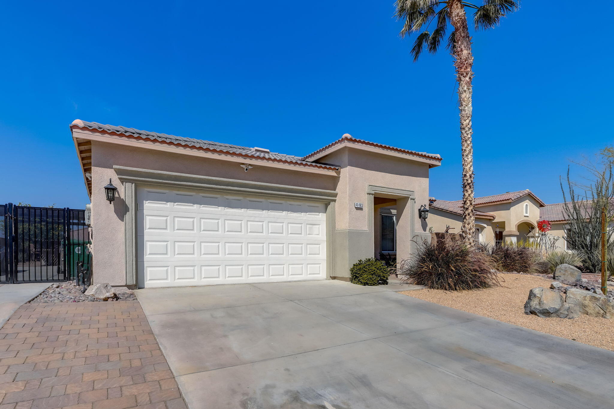 41163 Morris Street Indio, CA 92203 - Photo 6 of 83 a view of a house with a yard and garage