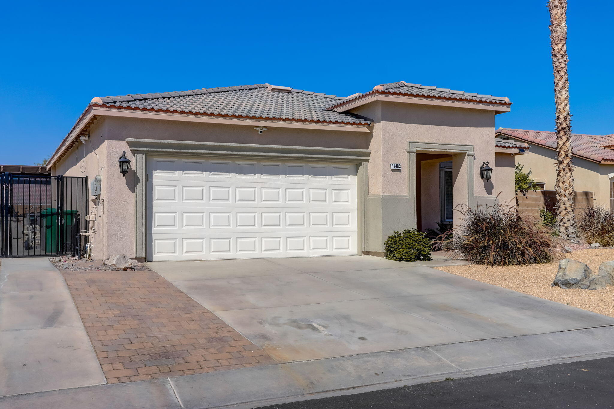 41163 Morris Street Indio, CA 92203 - Photo 7 of 83 a front view of a house with a yard and garage