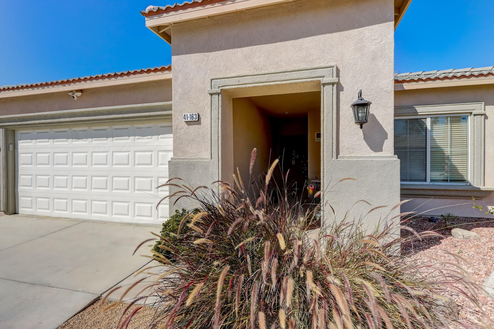 41163 Morris Street Indio, CA 92203 - Photo 10 of 83 a front view of a house with a yard