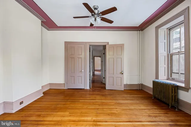 a view of room with wooden floor and windows